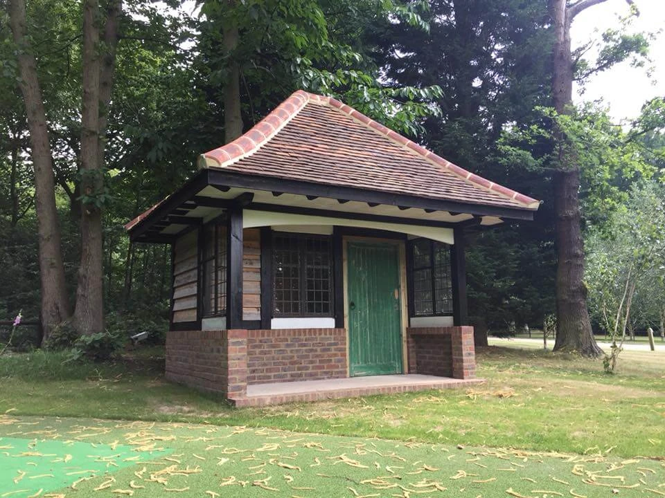Timber-framed garden pavilion with a brick base and newly clay-tiled hipped roof
